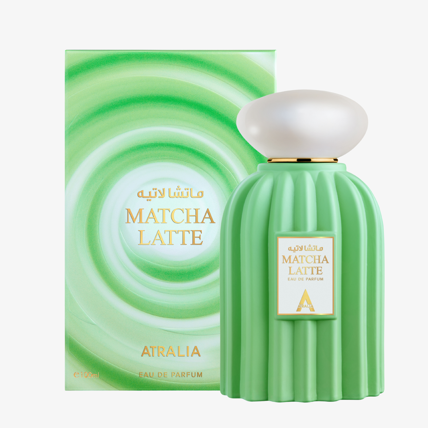 Atralia Matcha Latte set showcasing the swirl-patterned green box next to a fluted pastel-green bottle topped with a smooth, pearlescent white oval cap.