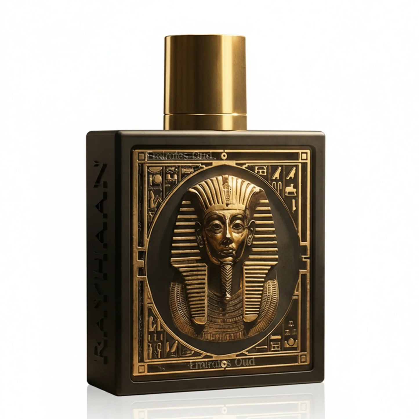 Frontal view of the square matte black flacon featuring a raised 3D metallic gold Pharaoh sarcophagus mask framed by intricate hieroglyphic borders, with "RAYHAAN" carved into the side and crowned with a smooth cylindrical gold cap.